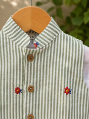 Close-up of green striped baby waistcoat with floral embroidery and natural buttons